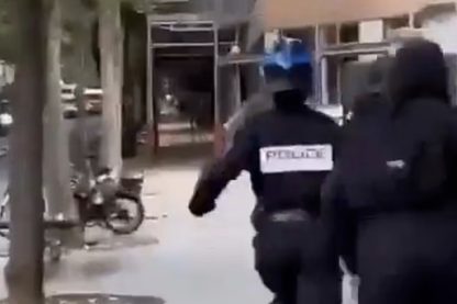 Policewoman is chased down the street, kicked to the ground and beaten by mob as riots rock France